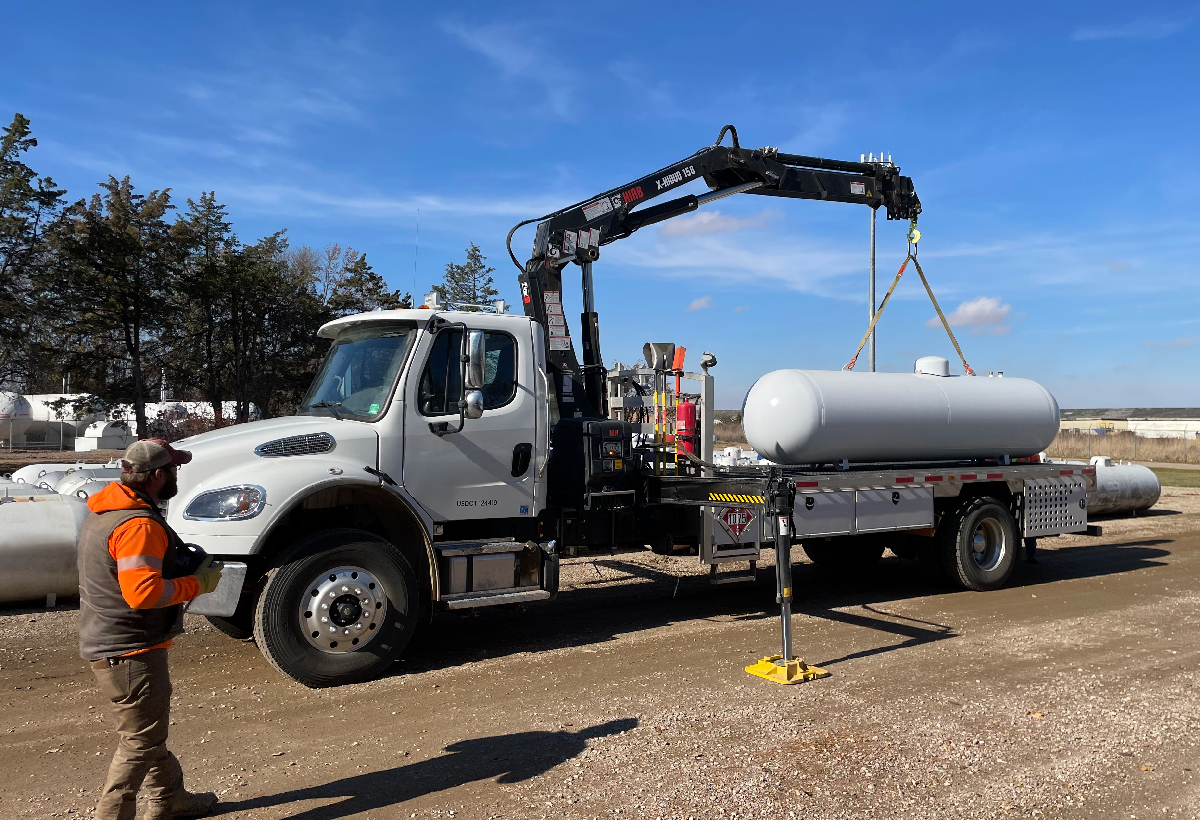 Loading a propane storage tank on a flat-bed truck