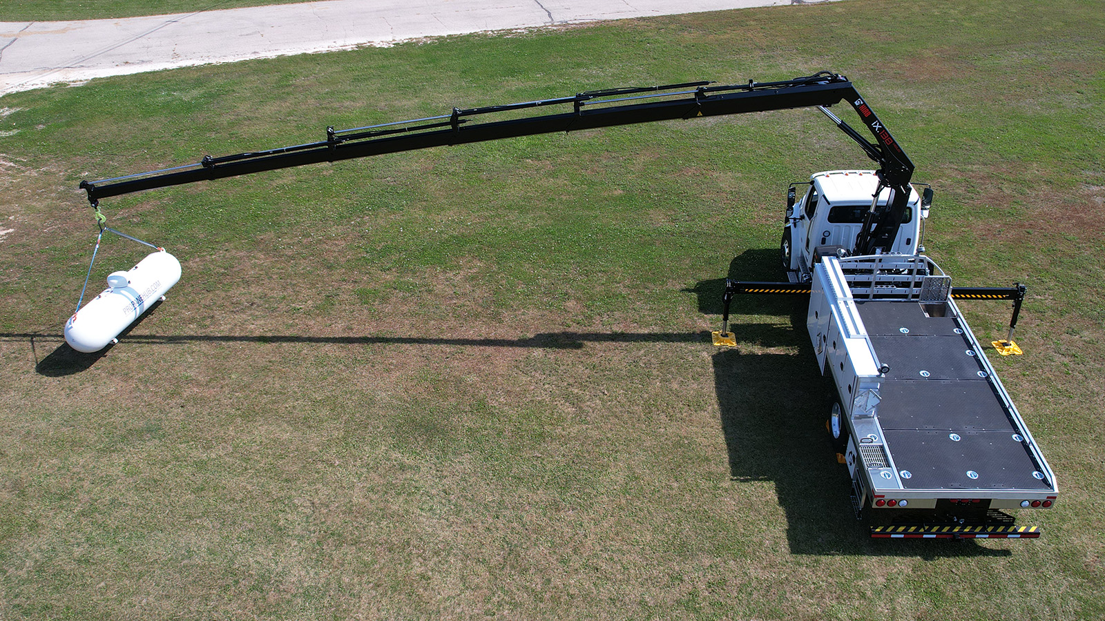 Loading a propane storage tank on a flat-bed truck